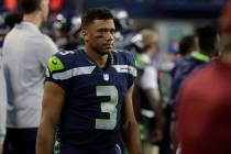 Seattle Seahawks quarterback Russell Wilson stands on the sideline during an NFL football prese ...