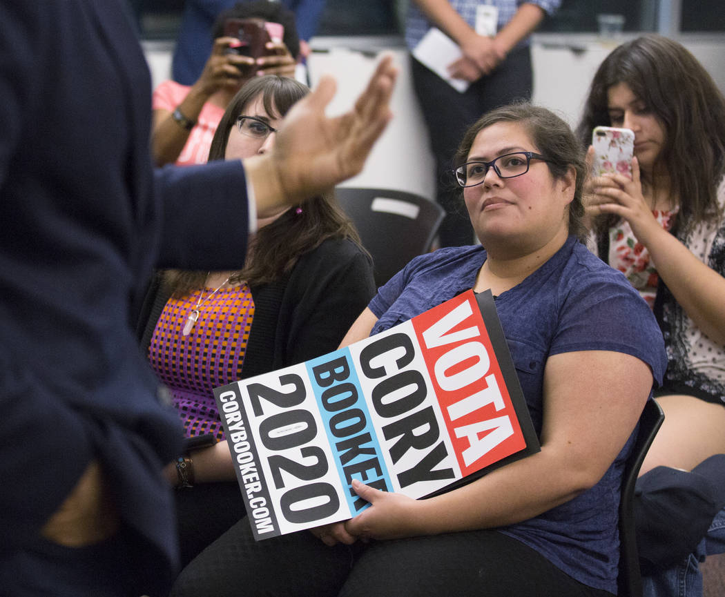 Anabel Chavva, right, listens to Democratic presidential candidate Sen. Cory Booker, D-N.J., sp ...