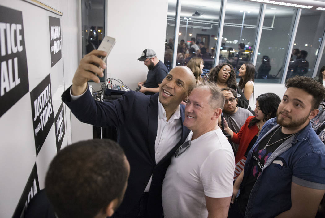 Democratic presidential candidate Sen. Cory Booker, left, D-N.J., takes a photo with Ed Russini ...