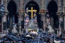Debris is seen inside Notre Dame cathedral in Paris, Tuesday, April 16, 2019. Firefighters decl ...