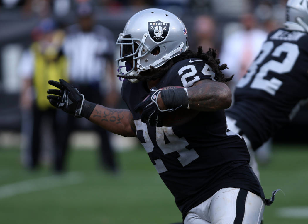 Oakland Raiders running back Marshawn Lynch (24) runs with the football against the Cleveland B ...