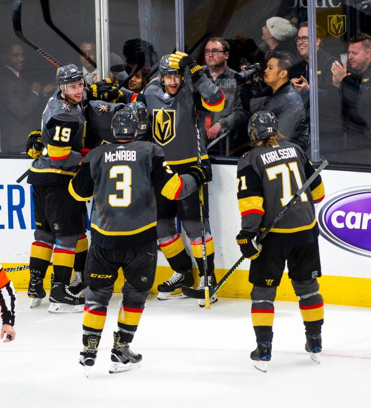 Golden Knights players celebrate a goal by defenseman Shea Theodore (27) during the first perio ...