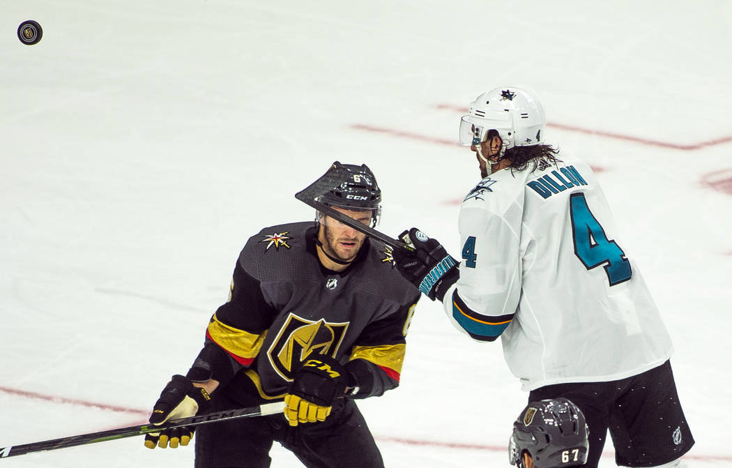 Golden Knights defenseman Colin Miller (6) receives a high stick to the face from San Jose Shar ...