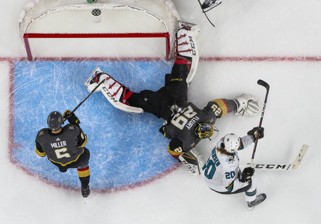 Golden Knights goaltender Marc-Andre Fleury (29) pounces on a shot by San Jose Sharks left wing ...