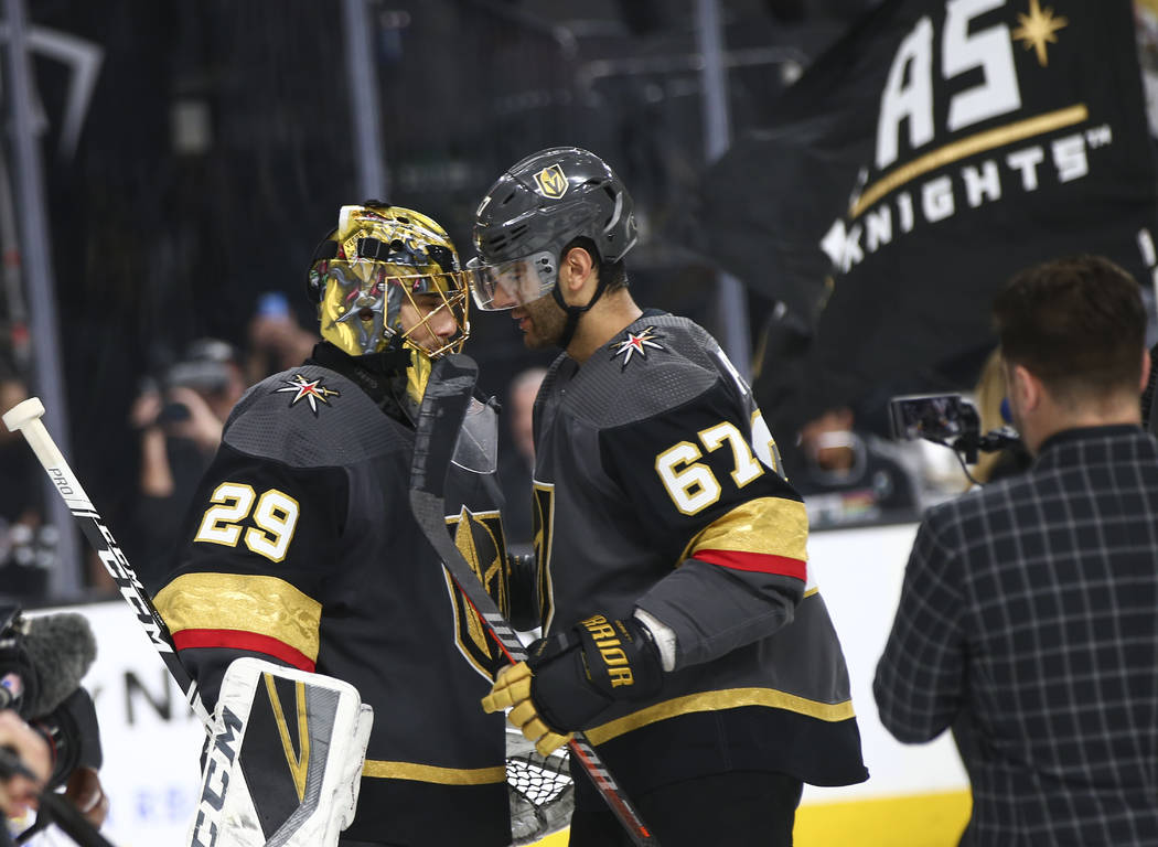 Golden Knights left wing Max Pacioretty (67) celebrates with goaltender Marc-Andre Fleury (29) ...