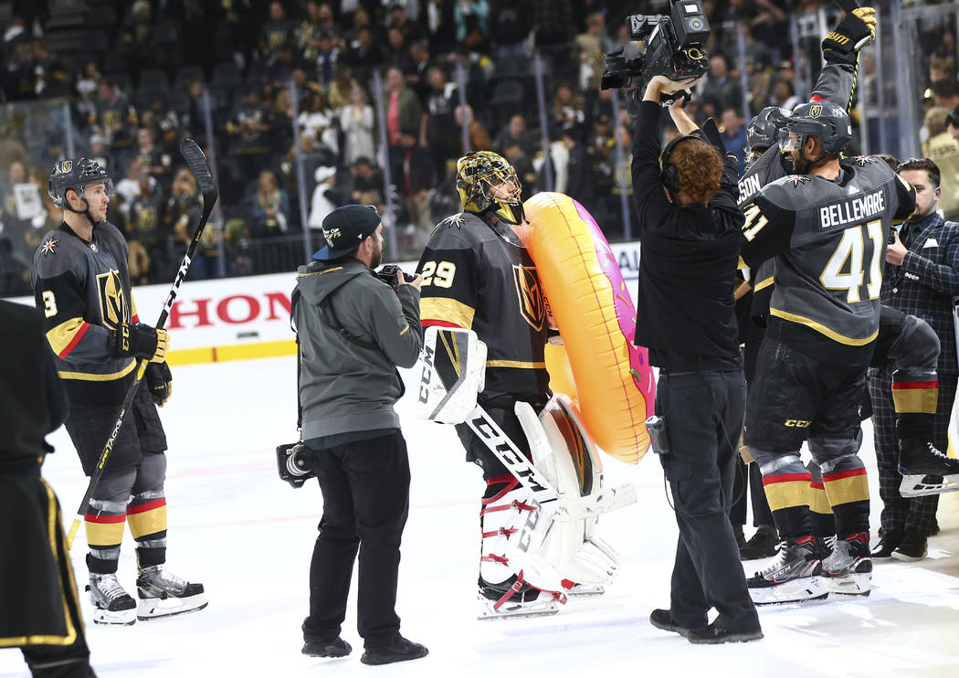 Golden Knights goaltender Marc-Andre Fleury (29) holds an inflatable donut after leading his te ...