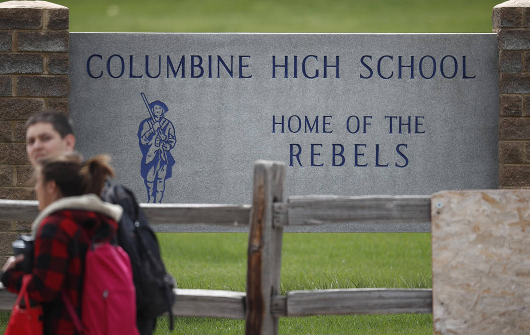 Students leave Columbine High School late Tuesday, April 16, 2019, in Littleton, Colo. Followin ...