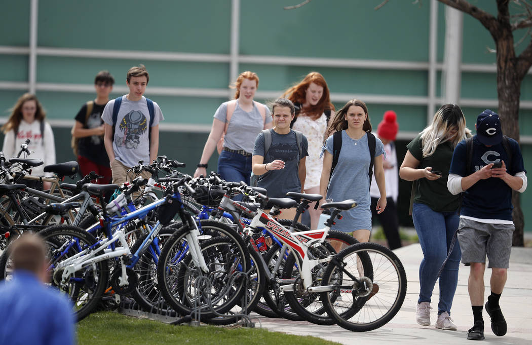 Students leave Columbine High School late Tuesday, April 16, 2019, in Littleton, Colo. Followin ...