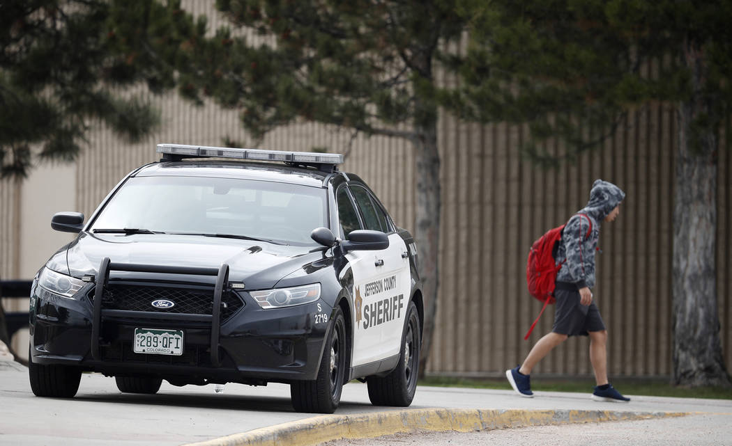 A student leaves Columbine High School late Tuesday, April 16, 2019, in Littleton, Colo. Follow ...