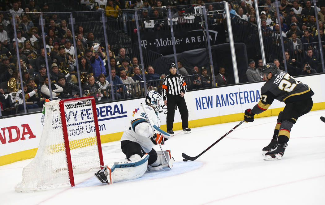 Golden Knights defenseman Shea Theodore (27) looks to score a goal past San Jose Sharks goalten ...