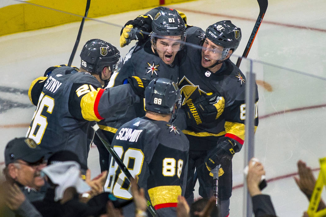 Golden Knights players celebrate the "hat trick" by their right wing Mark Stone (61), ...