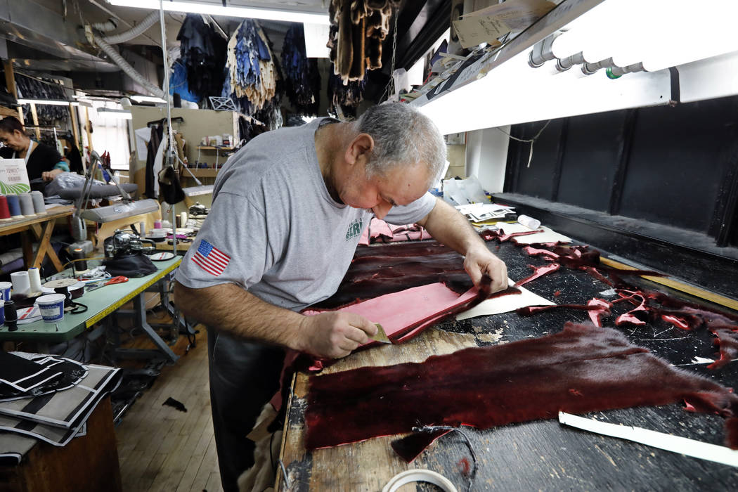 Master furrier Yanni Hilas makes a fur coat April 10, 2019, at Pologeorgis Furs in New York. La ...