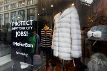 A sign by furnyc.org in the window of Victoria Stass Collection in New York's fur district on A ...