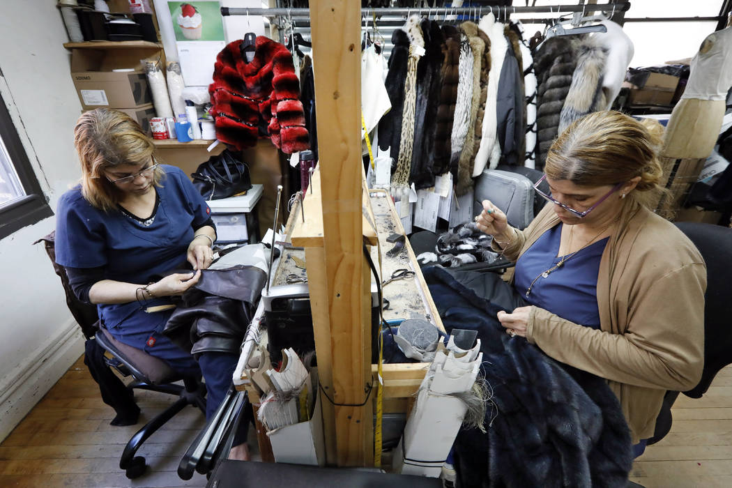 Samstresses Sonia Genao, left, and Juana Rodrize work April 10, 2019, on coats at Pologeorgis F ...