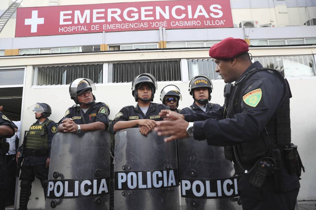 Peru's police officers stand guard at the emergency hospital Casimiro Ulloa where former Peruvi ...