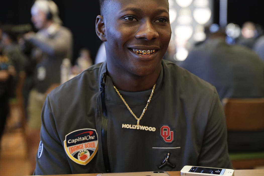 Oklahoma wide receiver Marquise Brown speaks to reporters during an NCAA college football media ...