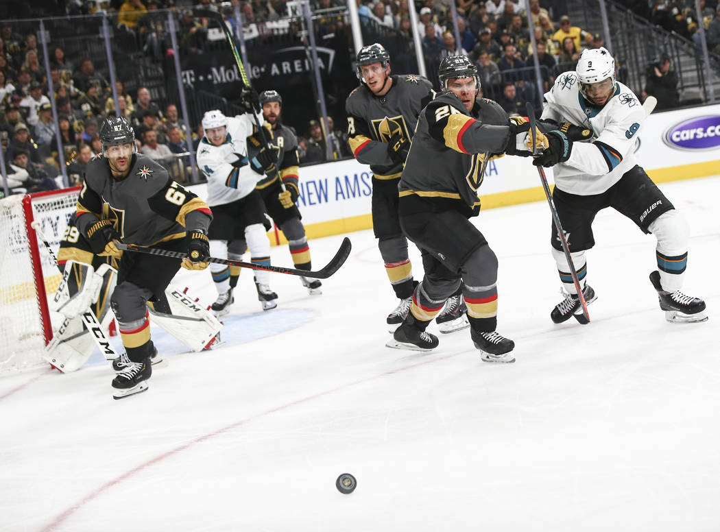 Golden Knights center Paul Stastny (26) and San Jose Sharks left wing Evander Kane (9) watch th ...