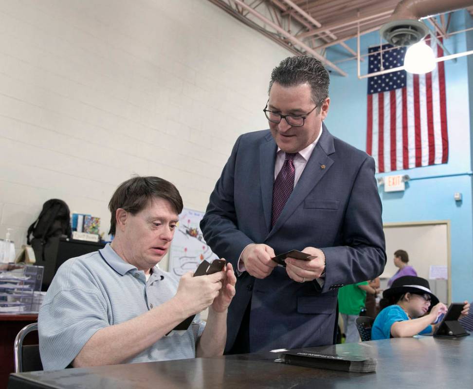 William O.., left, chats with Opportunity Village's Vice President of Philanthropy, Adam Joseph ...