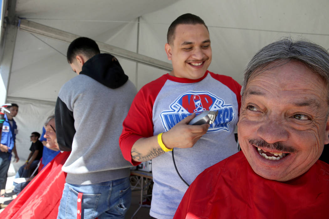 U.S. Navy veteran Fernando Gonzales, 56, and Sergio Bustillos, 30, share a laugh when they real ...
