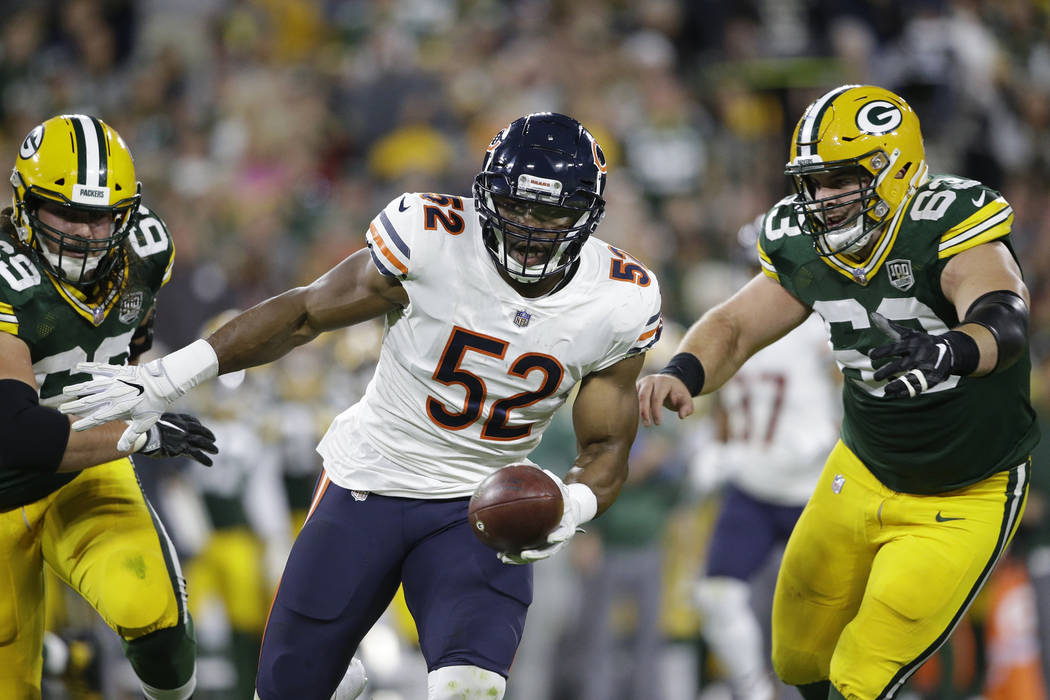 Chicago Bears' Khalil Mack intercepts a pass and returns it for a touchdown during the first ha ...