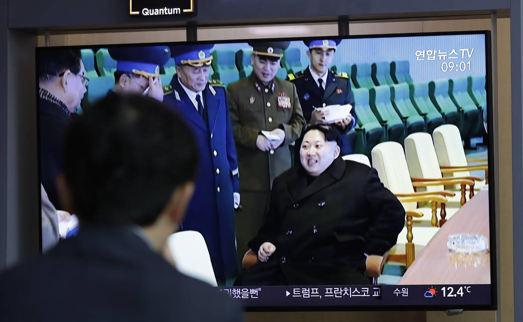 A man watches a TV news program reporting about North Korea's test-fire of a "new-type tac ...