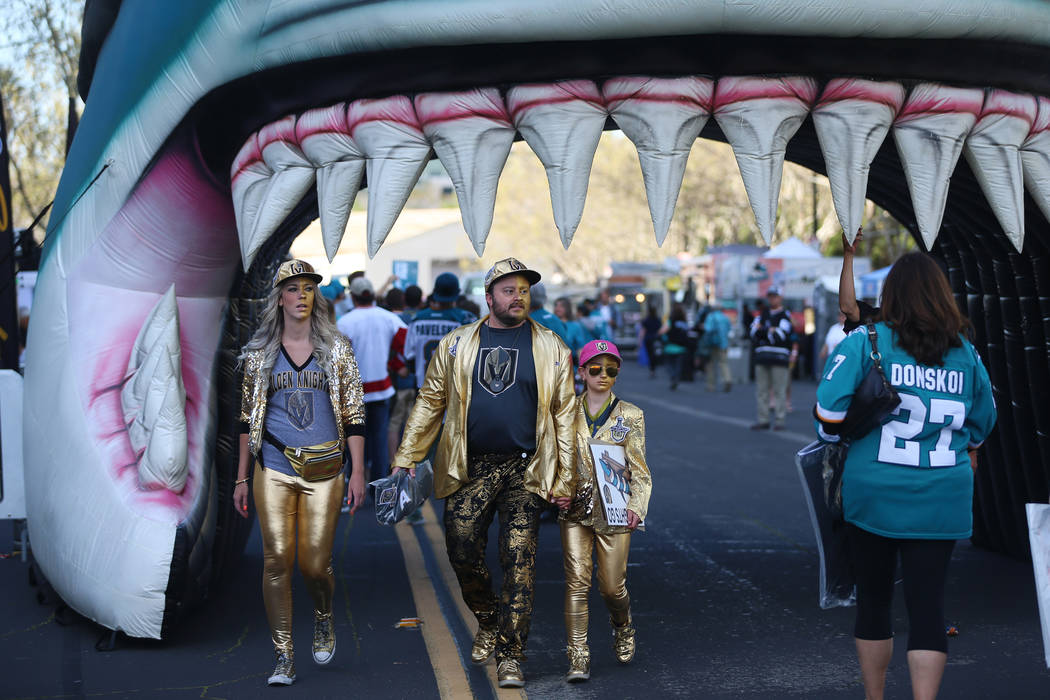 Casey Swank, from left, with Brad Ellis and his daughter Madeline, 11, from Las Vegas, walk out ...