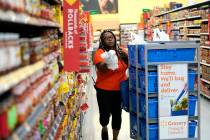 In this Nov. 9, 2018, file photo, Walmart associate Alicia Carter fulfills online grocery order ...