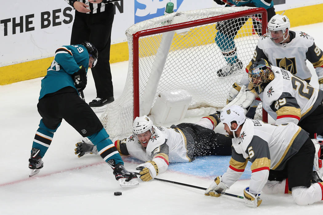 Vegas Golden Knights defenseman Brayden McNabb (3) defends against San Jose Sharks center Logan ...