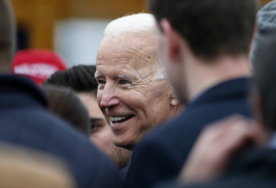 Former vice president Joe Biden talks with officials after speaking at a rally in support of st ...