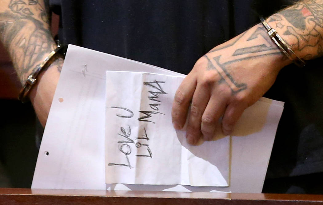 Jon Kennison, 27, displays a note as he appears in court at the Regional Justice Center in Las ...