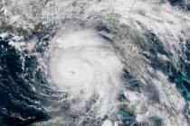 An Oct. 9, 2018, file satellite image provided by NOAA shows Hurricane Michael, center, in the ...