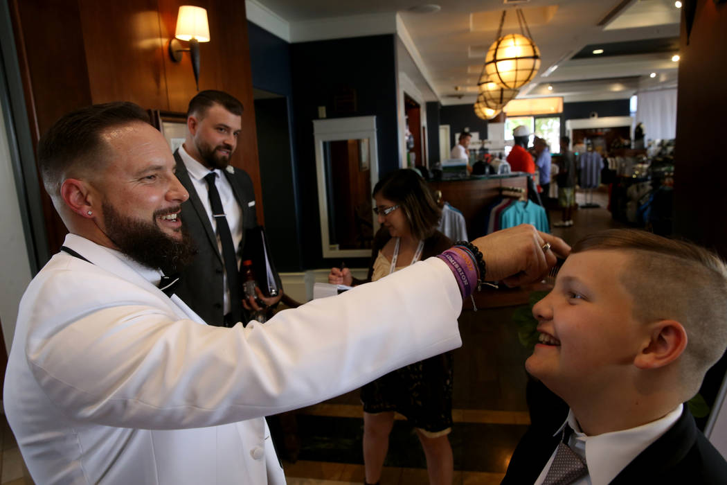 William King fixes his son Enoch's hair before marrying his bride Kimberly at the Revere Golf C ...