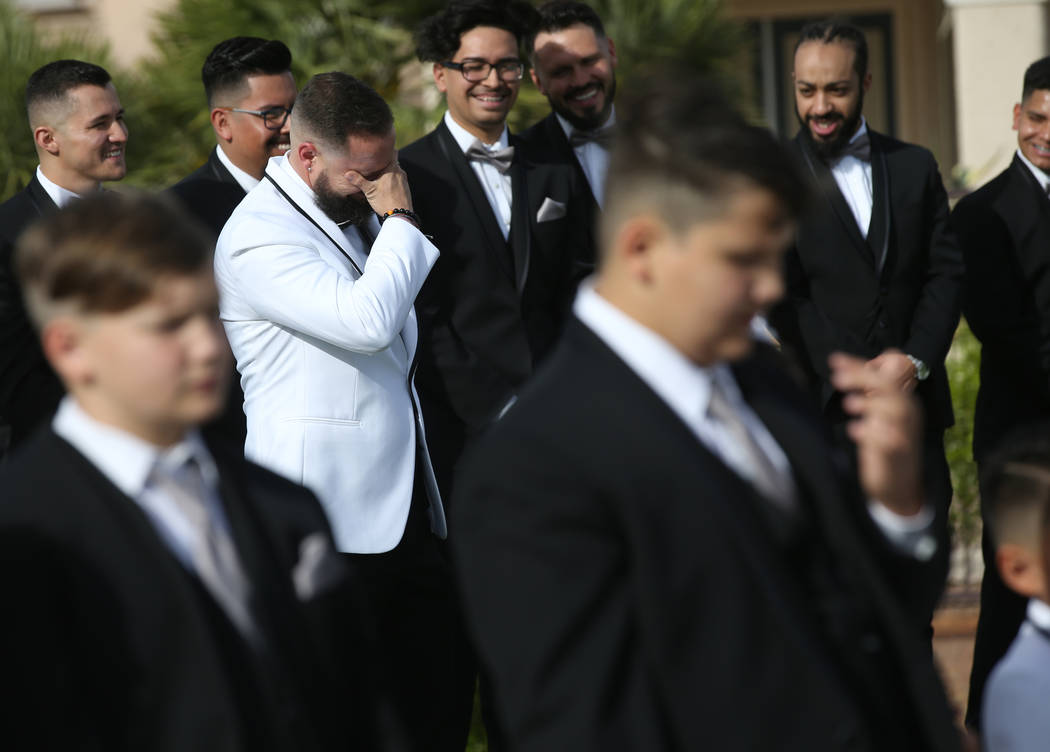 William King cries while his groomsmen laugh during his wedding ceremony at the Revere Golf Clu ...