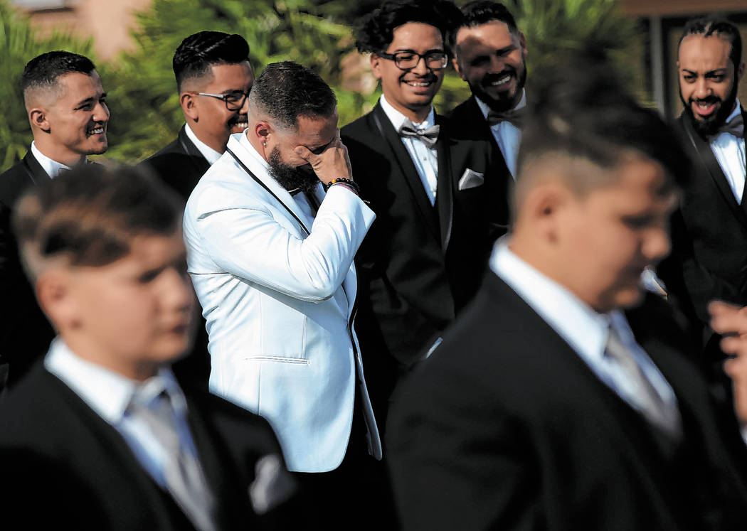William King cries while his groomsmen laugh during his wedding ceremony at the Revere Golf Clu ...