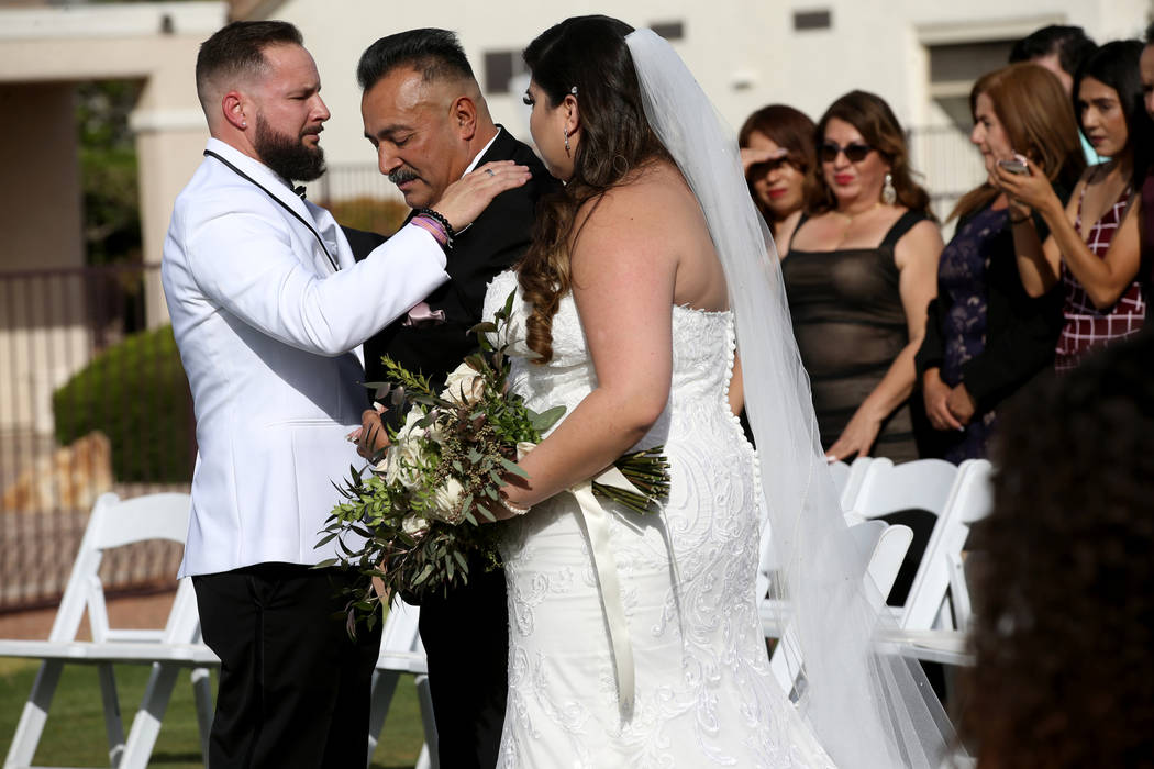 Kimberly King is given in marriage by her father Manuel Flores to her husband William King at t ...