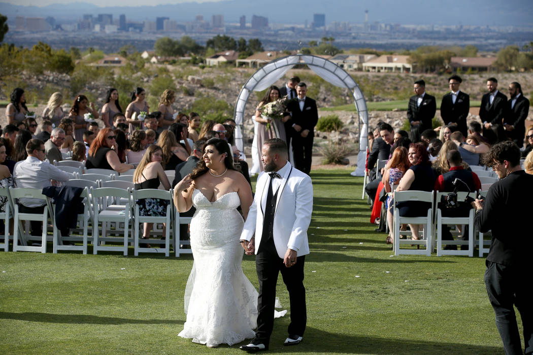 Kimberly and William King walk down the isle during their wedding ceremony at the Revere Golf C ...