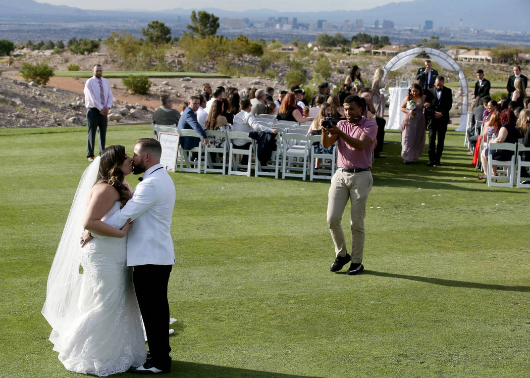 Kimberly and William King kiss after their wedding ceremony at the Revere Golf Club in Henderso ...