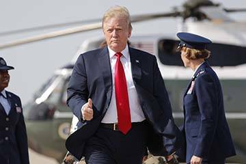 President Donald Trump gives a 'thumbs-up' as he prepares to board Air Force One, Thursday, Apr ...