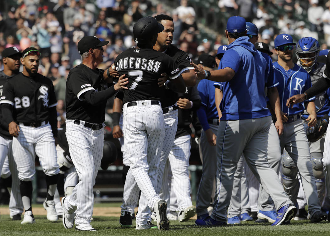Chicago White Sox's Tim Anderson (7) is restrained by Jose Abreu after he was hit by a pitch fr ...