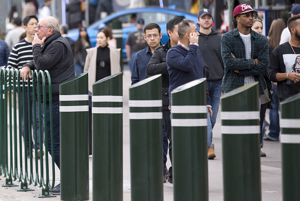 People walk past safety bollards on the Vegas Strip on Tuesday, Jan. 2, 2018. (Las Vegas Review ...