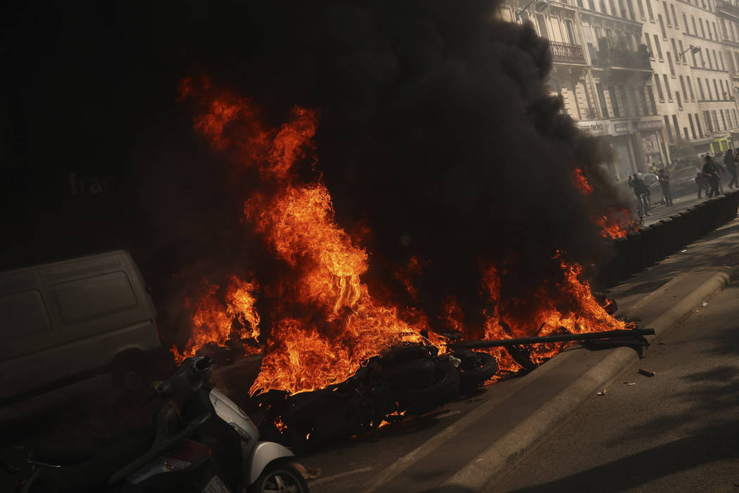 Motorbikes set alight during a yellow vest demonstration in Paris, Saturday, April 20, 2019. Fr ...