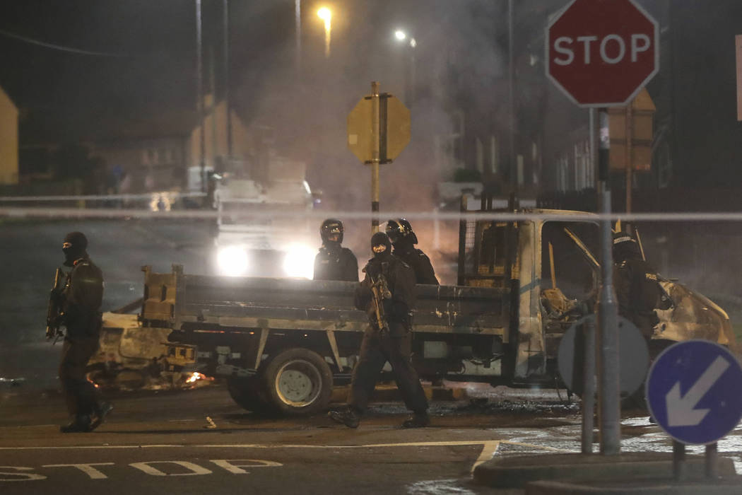 Police guard a crime scene during unrest in the Creggan area of Londonderry, in Northern Irelan ...