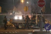 Police guard a crime scene during unrest in the Creggan area of Londonderry, in Northern Irelan ...