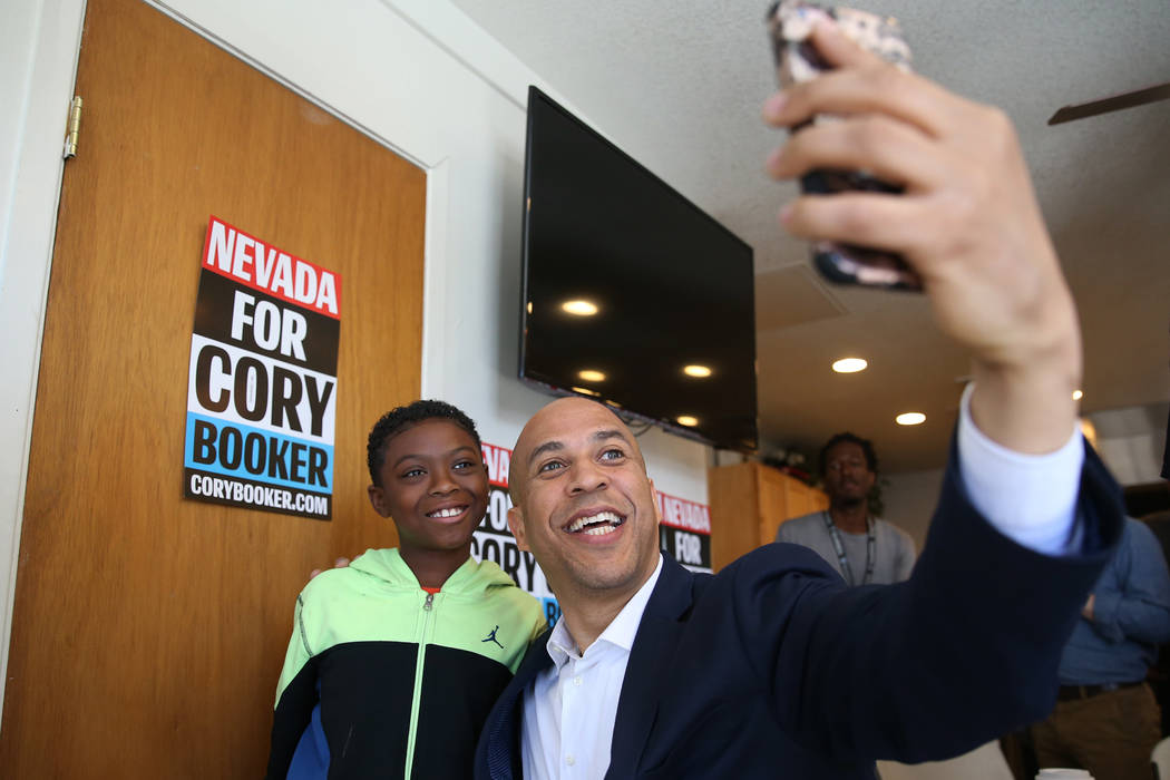Democratic presidential candidate Sen. Cory Booker, D-N.J., takes a photo with Jeremiah Daniels ...
