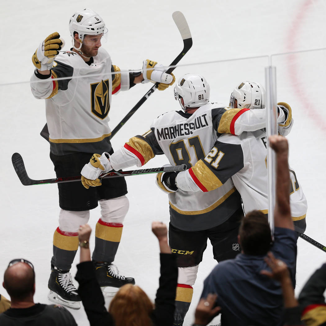 Vegas Golden Knights center Jonathan Marchessault (81) celebrates a score with center Cody Eaki ...