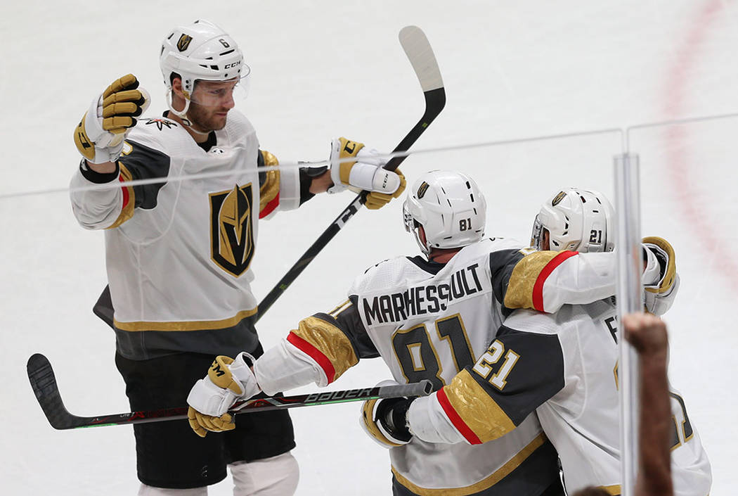 Vegas Golden Knights center Jonathan Marchessault (81) celebrates a score with center Cody Eaki ...