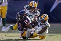 Chicago Bears wide receiver Allen Robinson (12) is tackled by Green Bay Packers cornerbacks Tra ...
