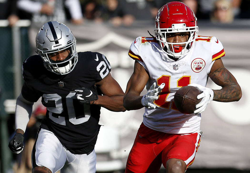 Kansas City Chiefs wide receiver Demarcus Robinson (11) runs in front of Oakland Raiders corner ...