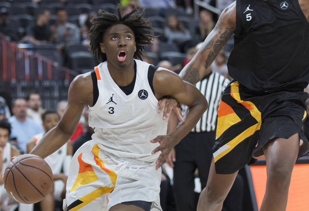 Tyrese Maxey (3) drives baseline past Armando Bacot Jr. (5) in the second half during the Jorda ...