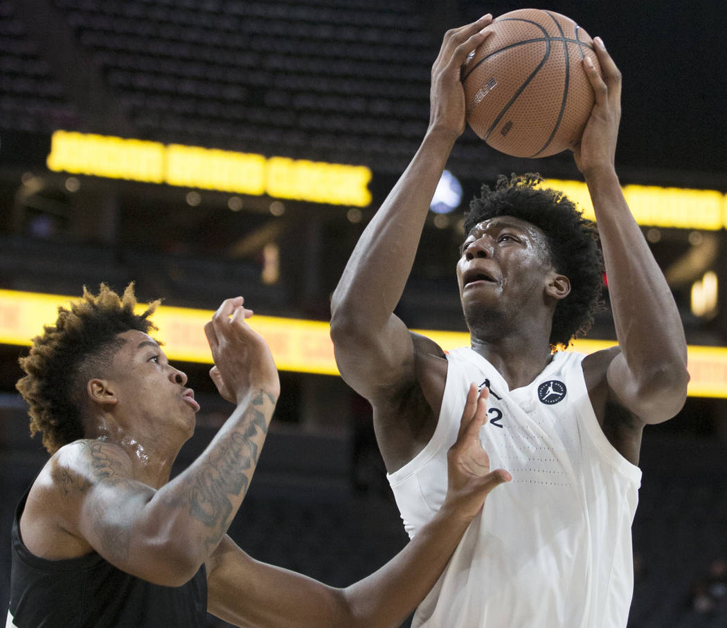 Kahlil Whitney (2) drives over Armando Bacot Jr. (5) in the second half during the Jordan Brand ...